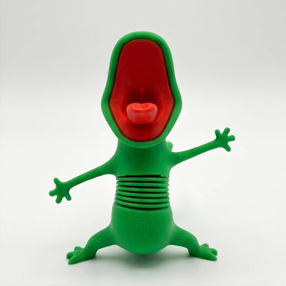 Green lizard figure with open mouth, long red tongue and spring neck, front view