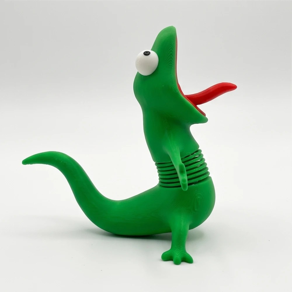 Green lizard figure with spring neck, side view